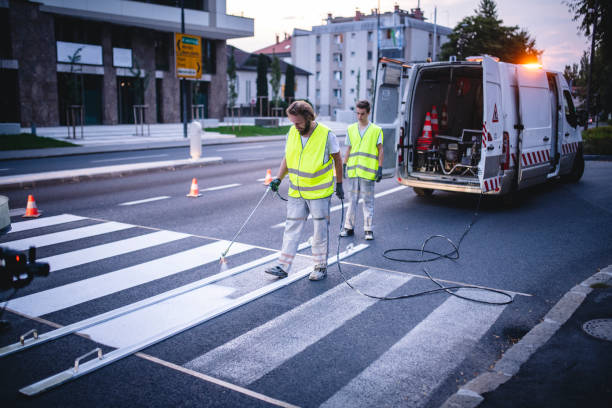 istock European Road Crew Repainting Zebra Crossing at Sunset 1179947041