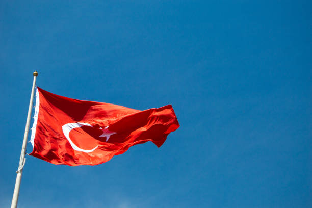 istock Turkish national flag with white star and moon in sky 1179948426