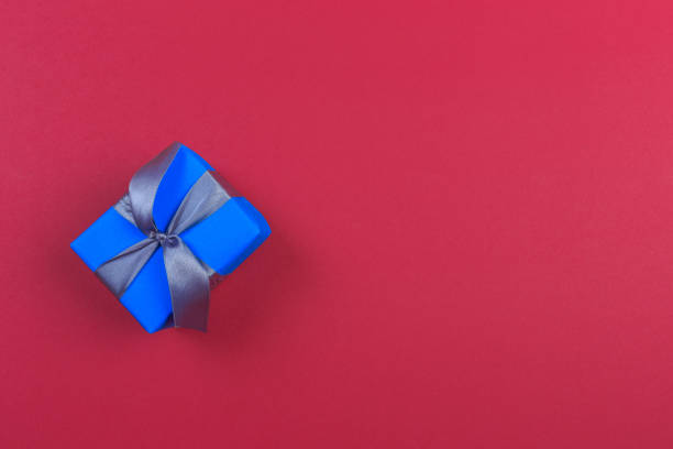 istock Gift box with ribbon and bow on color background and space for text. Top view 1179949788