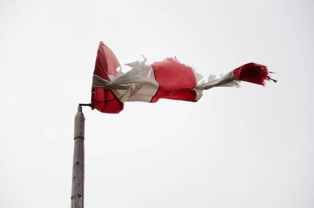 istock Old striped torn weather vane on cloudy summer day 1179950394