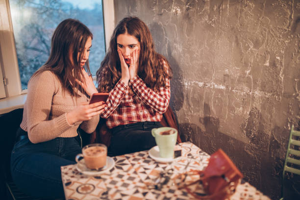 Two female friends on a coffee break downtown