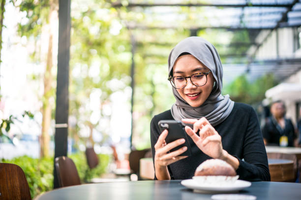 istock Cheerful Malaysian girl using her smartphone 1179953358
