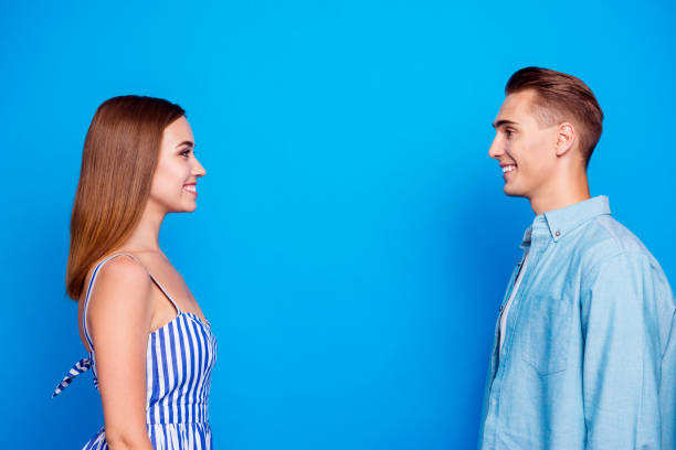 istock Profile side view portrait of her she his he two nice attractive charming lovely content cheerful cheery people looking at each other isolated over bright vivid shine vibrant blue color background 1179953548