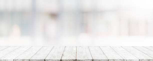 istock Empty wood table top and blur glass window wall building banner mock up abstract background - can used for display or montage your products. 1179954680