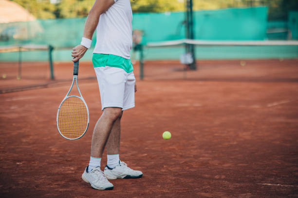 istock Tennis player standing on clay court 1179955757