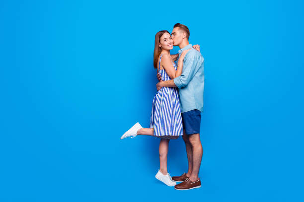 istock Vertical profile side view of his he her she two nice attractive charming lovely cheerful cheery people holding hands isolated over bright vivid shine vibrant blue turquoise color background 1179955828