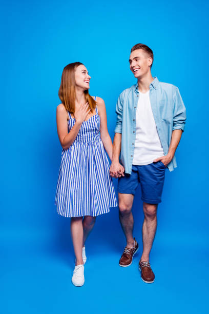istock Vertical full length body size view of his he her she two nice attractive charming delighted cheerful cheery people walking isolated over bright vivid shine vibrant blue turquoise color background 1179955968