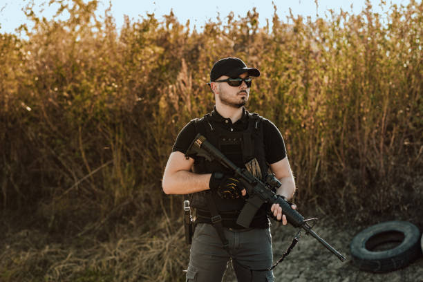 istock Private security member with shooting rifle outdoors, portrait. 1179956379