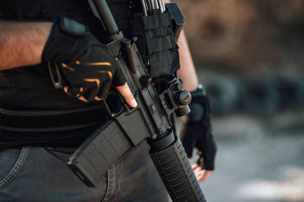 istock Private security concepts. Close-up image of a man with rifle. 1179956395