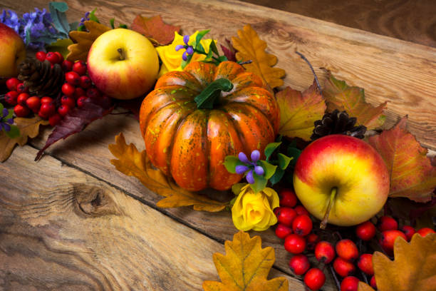 istock Fall wreath with pumpkin, purple flowers, apples 1179957195