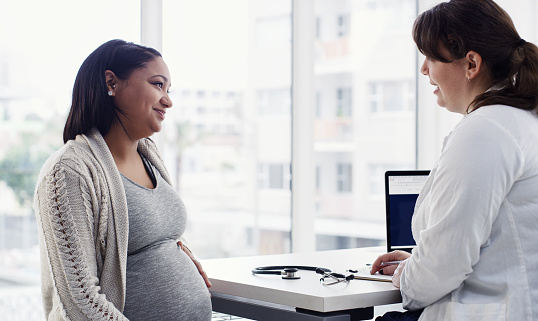 Shot of a pregnant young woman having a consultation with her doctor at a clinic