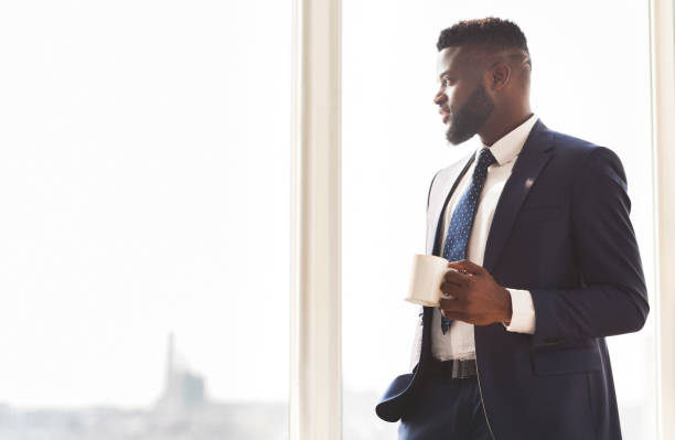 istock Young successful businessman drinking coffee in office 1179958021