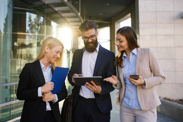 istock Business team discussing business outdoors using digital tablet 1179958693