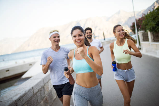 istock Group of young people jogging and running outdoors in nature 1179959606