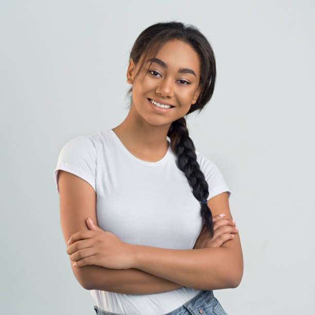 istock Asian student girl with arms crossed over grey wall 1179961276