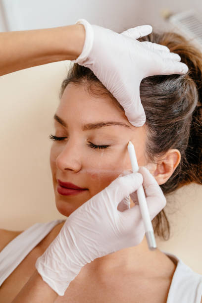istock Beautiful woman's face is being prepared for plastic surgery 1179961493