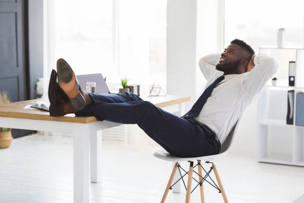 istock Joyful young manager relaxing on chair in white modern office 1179961531