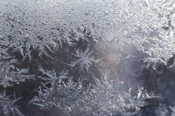 istock snow pattern on the glass from frost 1179961818