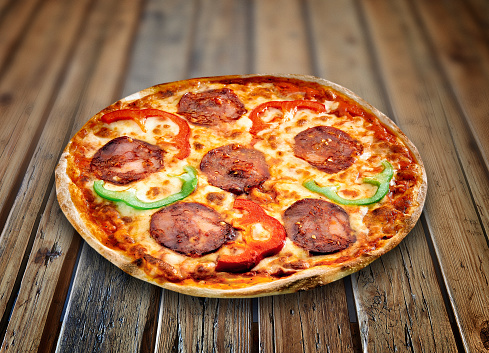Pizza Siciliana on a textured wooden table