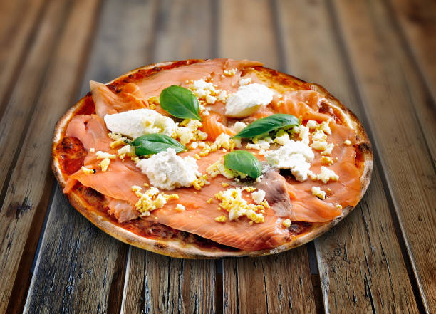 istock Plate on wooden table with a delicious pizza 1179962959
