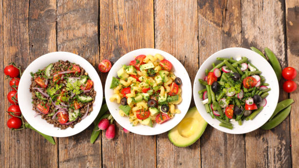 istock mixed vegetarian salad in bowl, top view 1179964279