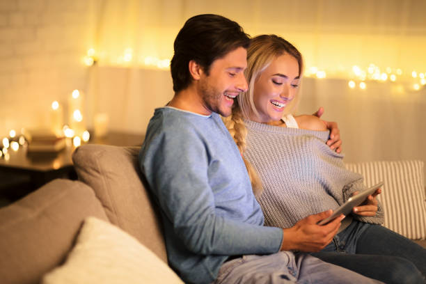 istock Young couple using tablet pc in cozy living room 1179965858