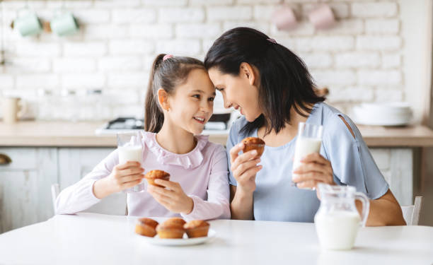 istock Mother and daughter having a bite in kitchen 1179966162