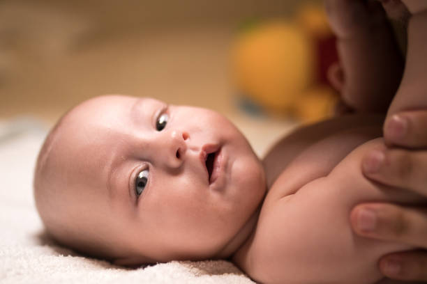 Baby exercising on the bed