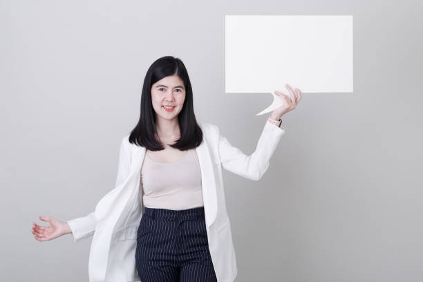 istock Smiling happy Asian woman with blank speech bubbles 1179968275