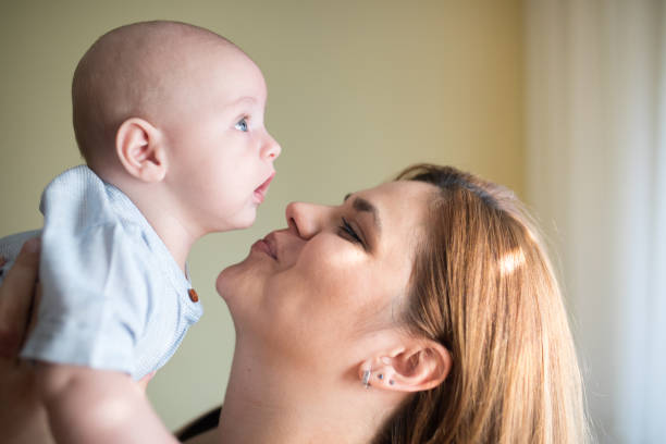 istock Mother cuddles with baby 1179968577