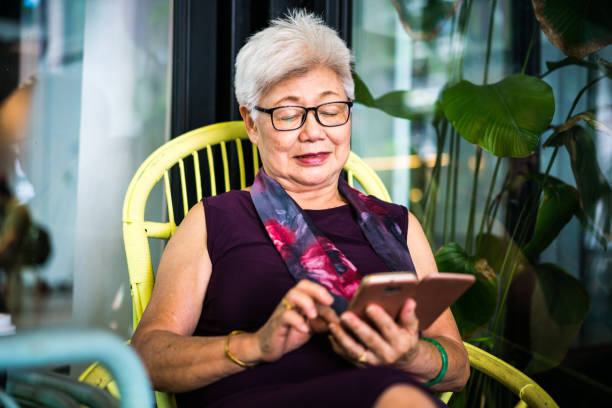 istock Senior Asian woman using her smartphone 1179969648