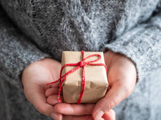 istock Woman with gift with red bow in her hands, christmas 1179971050