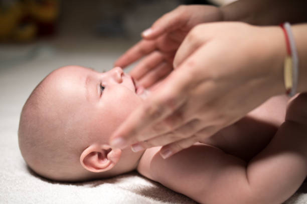 istock Mother cuddles with baby 1179971218