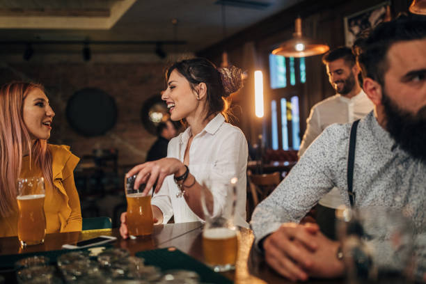 istock Modern people sitting in pub at the bar 1179971568