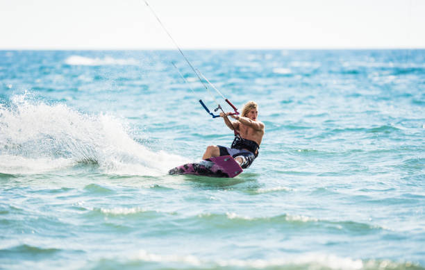 istock Athletic man having fun while kitesurfing on the sea. 1179971606