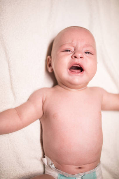 istock Baby in diapers on the bed 1179971652
