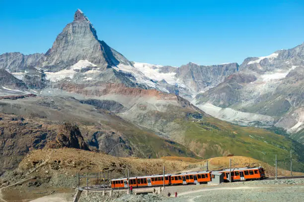 red train on the background of Matterhorn peak in the Swiss Alps (  Pennine Alps )