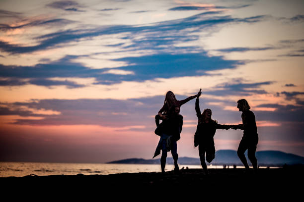 istock Carefree couples having fun in autumn on the beach. 1179972647