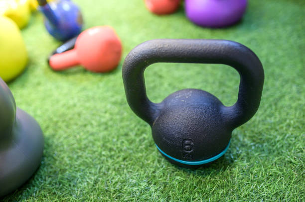 kettlebell training on artificial grass in the gym. - kettle bell activity aerobics athlete imagens e fotografias de stock