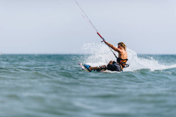 istock Young man enjoying in kiteboarding during summer day at sea. 1179973013