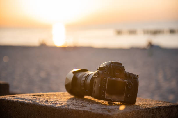 istock professional dslr camera on the sand on the beach. Dust proof 1179973670