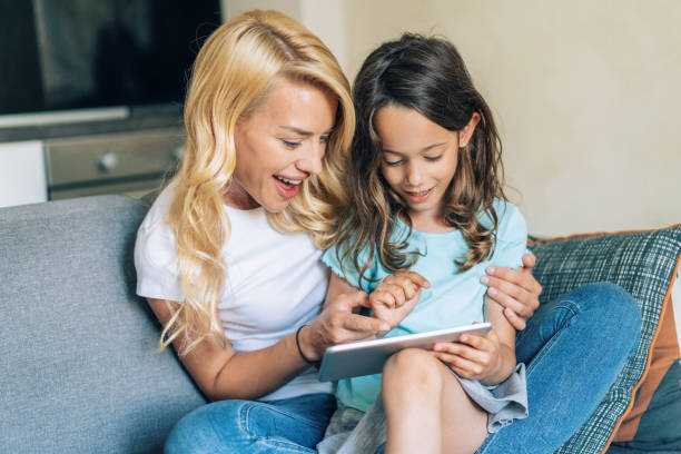 istock Mother and daughter looking at digital tablet 1179975315
