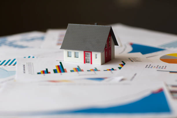 istock Miniature House on A Financial Graph 1179975591