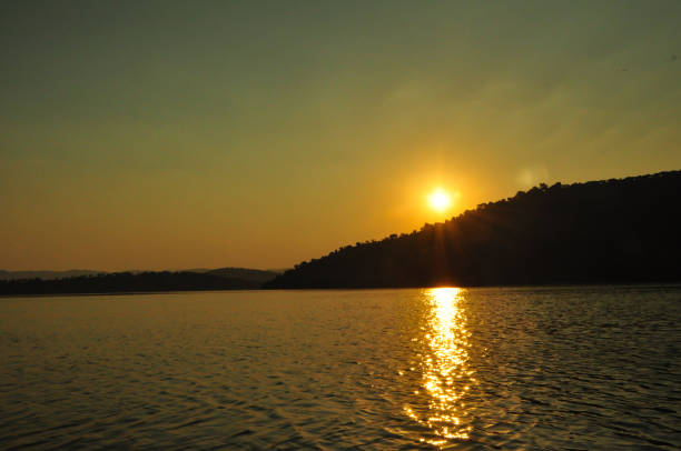 istock Lake, seascape, backlight, sunset, afternoon, beautiful landscape, setting sun behind hills 1179975816