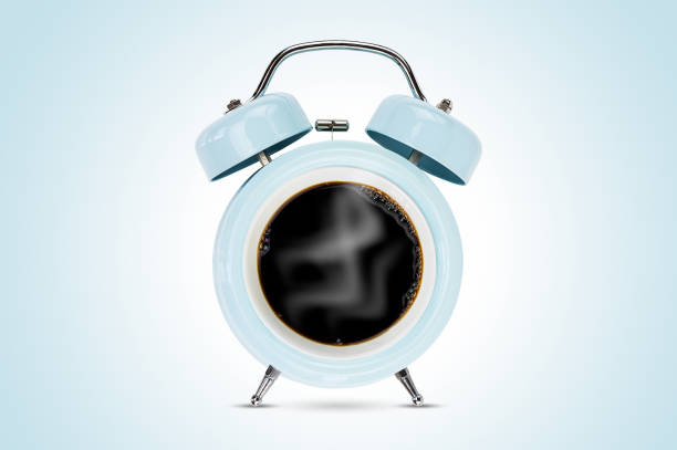 Coffee cup with blue alarm clock isolated on blue background