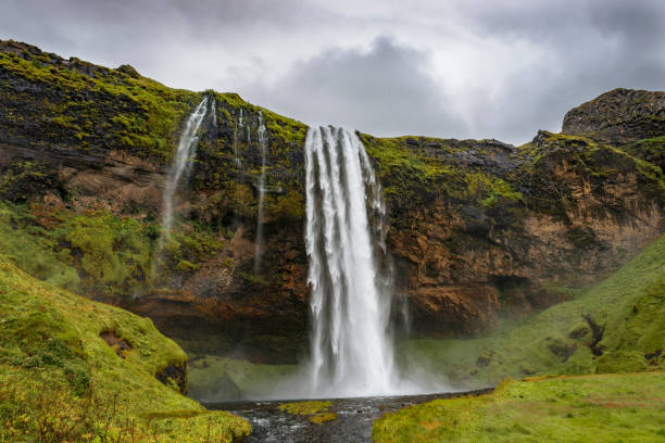 This is a photograph of the top of the waterfall, Seljalandsfoss in the Southern region of Iceland on a cold overcast day.