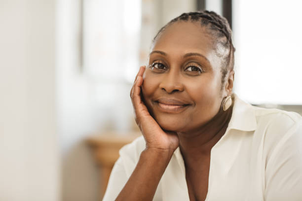 istock African American woman smiling while sitting in her kitchen 1179977461