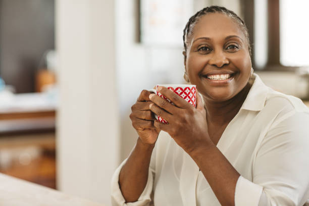 istock African American woman smiling while having coffee in her kitchen 1179978137