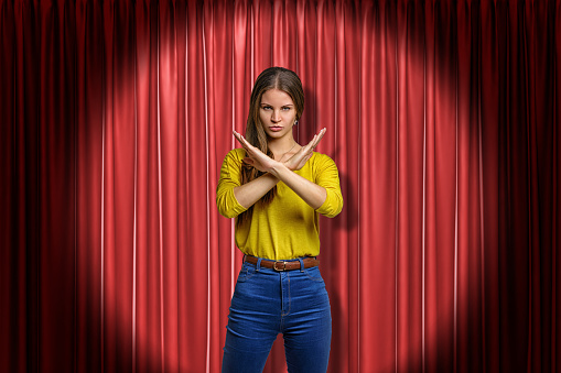 Verandering Veraangenamen Symfonie Young Determined Woman Wearing Jeans And Yellow Shirt Making Rejection  Gesture On Red Stage Curtains Background Stock Photo - Download Image Now -  iStock
