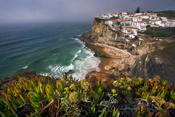 Dreamy view of the picturesque village Azenhas do Mar ins sunset light with chalk houses on the edge of a cliff and beach below. Sintra Landmark, Portugal, Europe Dreamy view of the picturesque village Azenhas do Mar ins sunset light with chalk houses on the edge of a cliff and beach below. Sintra Landmark, Portugal, Europe. azenhas do mar stock pictures, royalty-free photos & images